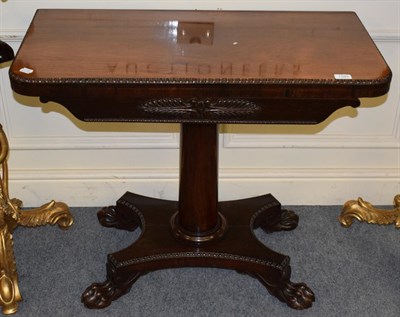 Lot 1284 - A Regency mahogany fold over card table, the rectangular top with rounded corners and carved...