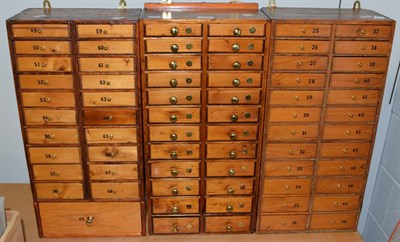 Lot 1000 - Three small watchmaker's drawer cabinets containing watch parts; stems; staffs; hands; winding...