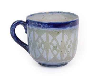 Lot 1004 - A Martin Brothers Stoneware Cup, decorated with a repeating pattern, between blue bands and handle