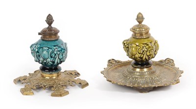 Lot 1012 - Two Linthorpe Pottery Inkwells, moulded with the faces of cherub, in green and turquoise glaze,...