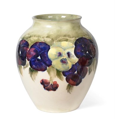 Lot 1034 - William Moorcroft (1872-1945): A Pansy Pattern Vase, circa 1913-16, in purple, yellow and green...