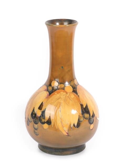 Lot 1040 - William Moorcroft (1872-1945): A Yellow Flambé Leaf and Grape Pattern Vase, impressed marks,...