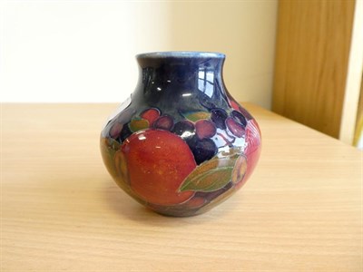 Lot 1043 - William Moorcroft (1872-1945): A Pomegranate Pattern Vase, on a blue ground, impressed...
