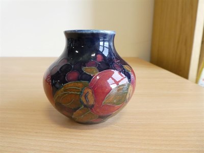 Lot 1043 - William Moorcroft (1872-1945): A Pomegranate Pattern Vase, on a blue ground, impressed...