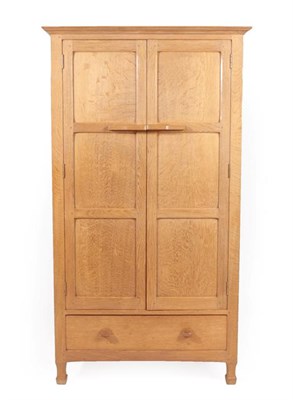 Lot 1159 - Keith L Moorey (1930-2019): A Panelled English Oak Wardrobe, made in 1968, the overhanging...