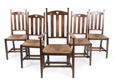 Lot 1183 - A Set of Five (4+1) Arts & Crafts Stained Oak Dining Chairs, the top rail with pierced heart motif