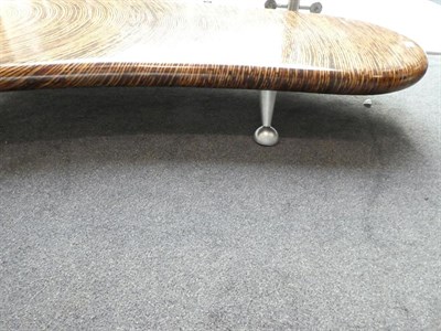 Lot 1214 - A Clayton Tugonon Coffee Table, curved form with circular hole, on silver coloured legs,...