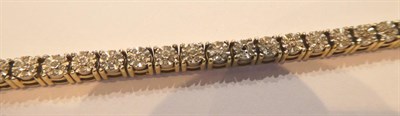 Lot 71 - A 9 carat gold diamond line bracelet, length 19cm