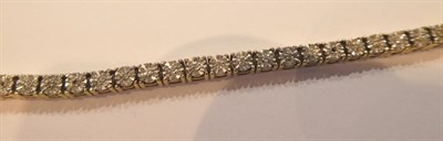 Lot 71 - A 9 carat gold diamond line bracelet, length 19cm
