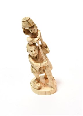 Lot 83 - A late 19th century carved ivory figure of a man and child