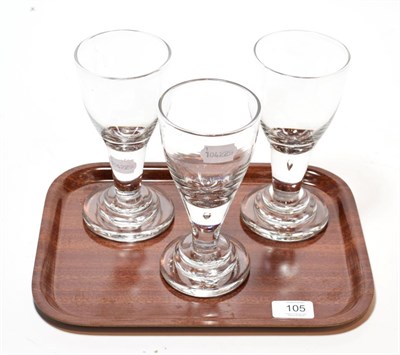Lot 105 - A set of three glass rummers, tear drop inclusion to stems, stepped bases, pontil marks (3)