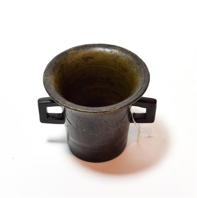 Lot 113 - A bronze mortar, possibly German, 16th/17th century, of flared cylindrical form with angular...