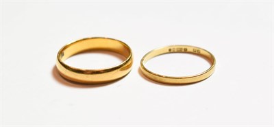 Lot 143 - A 22 carat gold band ring, finger size P; and an 18 carat gold band ring, misshapen
