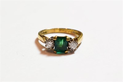 Lot 153 - An 18 carat gold emerald and diamond three stone ring, finger size I1/2