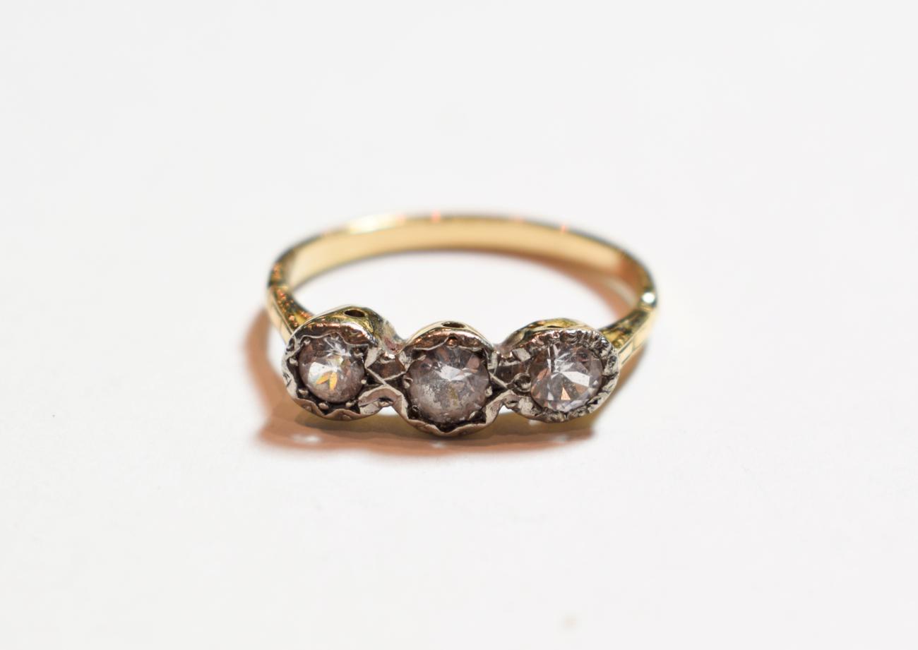 Lot 156 - A diamond three stone ring, finger size T