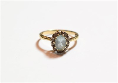 Lot 161 - A 9 carat gold aquamarine and diamond cluster ring, finger size L