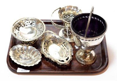 Lot 230 - A collection of silver, including: a George V silver sugar-basket, in the George III style,...