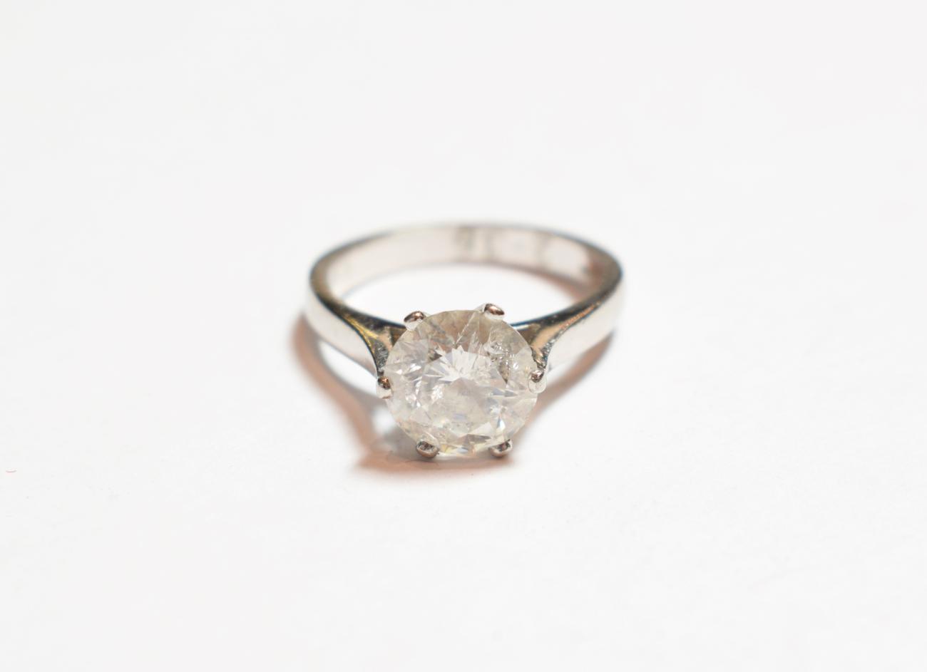 Lot 308 - A platinum diamond solitaire ring, the round brilliant cut diamond in a six claw setting on a...