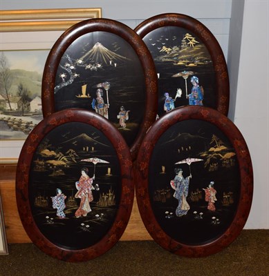 Lot 1057 - A set of four Japanese lacquered oval panels depicting figures