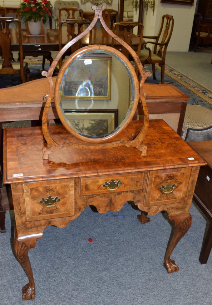Lot 1076 - A reproduction walnut lowboy and a reproduction walnut dressing table mirror