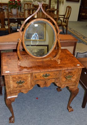 Lot 1076 - A reproduction walnut lowboy and a reproduction walnut dressing table mirror