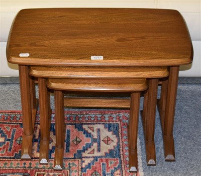 Lot 1077 - A nest of Ercol oak tables with faceted legs, Golden Dawn design