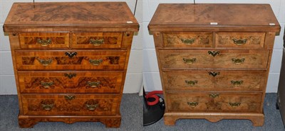 Lot 1097 - A matched pair of reproduction walnut bachelors' chests, each with fold over top
