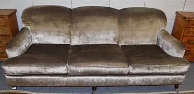 Lot 1098 - A three seater modern sofa upholstered in plush grey velvet