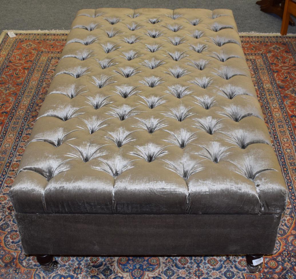 Lot 1099 - A reproduction box footstool upholstered in button grey fabric