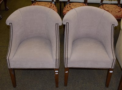 Lot 1104 - A pair of modern tub chairs upholstered in light brown fabric
