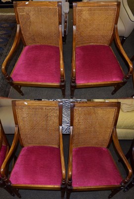 Lot 1107 - A set of four reproduction armchairs with cane back supports and drop in seats