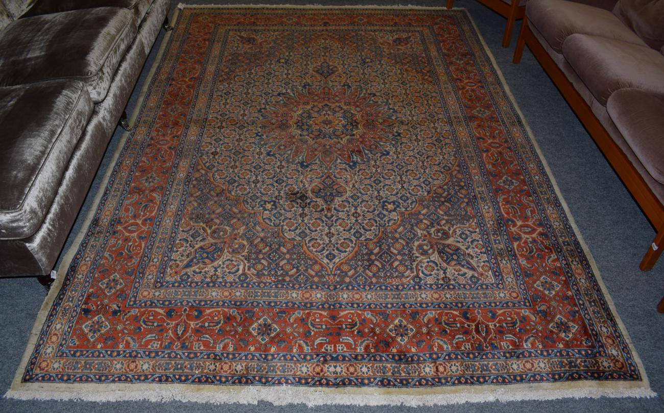 Lot 1127 - Mud carpet, the ivory Herati field centred by a flowerhead medallion framed by brick red...