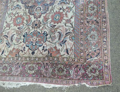 Lot 1129 - An Isfahan rug, the cream field of large flowerheads around an indigo medallion, framed by palmette
