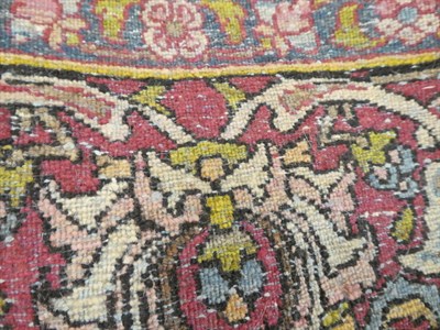 Lot 1129 - An Isfahan rug, the cream field of large flowerheads around an indigo medallion, framed by palmette