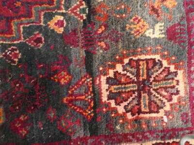 Lot 1132 - Kashgai rug, the stepped aubergine field with cruciform medallion, enclosed by narrow borders,...