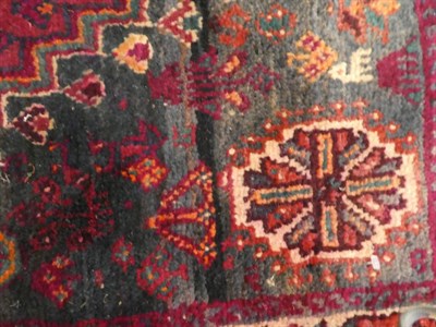 Lot 1132 - Kashgai rug, the stepped aubergine field with cruciform medallion, enclosed by narrow borders,...