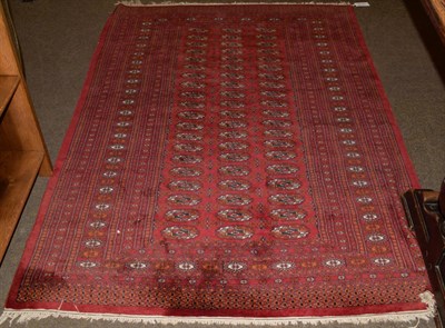 Lot 1141 - Lahore Bukhara Rug, the crimson field of guls enclosed by multiple narrow borders, 187cm by 129cm