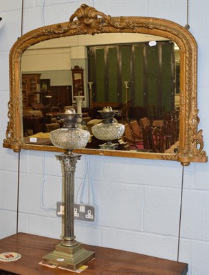 Lot 1146 - A gilt framed over mantel mirror; and a Corinthian column oil lamp (drilled)