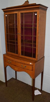 Lot 1149 - A reproduction walnut glazed bookcase on stand