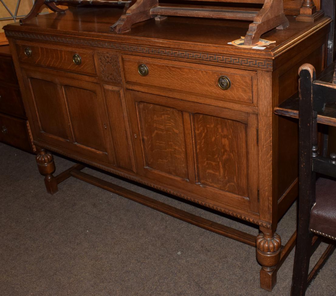 Lot 1168 - An early 20th century oak sideboard with Greek key moulded frieze, above two drawers and two...