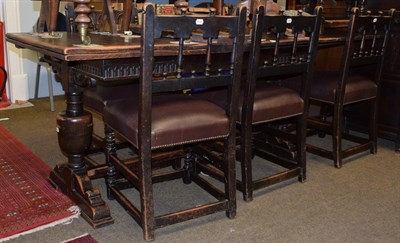Lot 1169 - A 1920s oak extending dining table; together with a set of six matching chairs, including one...