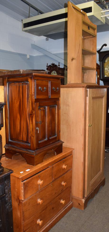 Lot 1172 - A pine three height chest; a pine cupboard; a modern narrow bookcase; and a modern hardwood bedside
