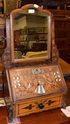 Lot 1190 - A 19th century parquetry inlaid dressing box, the swivel mirror above a slant front decorated...