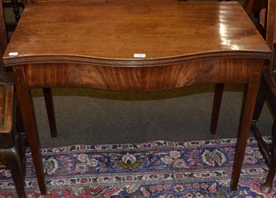 Lot 1197 - A George III mahogany serpentine shaped tea table, fold over top, inlaid shell paterae, square...