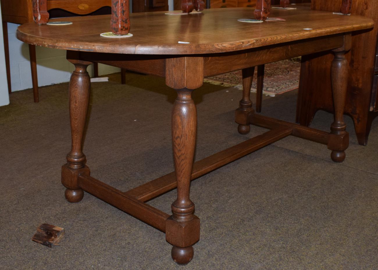 Lot 1199 - An oak trestle based dining table