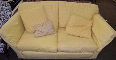 Lot 1211 - A mahogany framed two seater sofa upholstered in mustard yellow fabric
