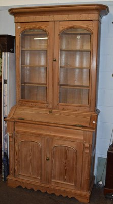 Lot 1241 - A late 19th/early 20th century pine bureau bookcase with shaped apron; and a four leaf printed...