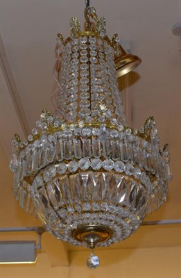 Lot 1265 - A gilt metal and cut glass chandelier