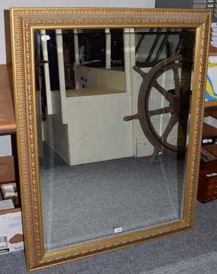 Lot 1268 - A reproduction bevel glass gilt farmed mirror 117cm by 90cm