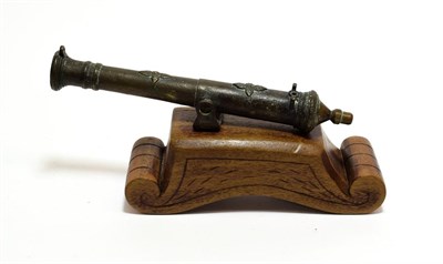 Lot 2117 - A Malaysian Small Lantaka, the 22cm bronze barrel applied with cast leaves, with hinged gimbal on a